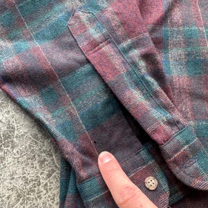 May include: A white ceramic mug with a black handle and the text "But First, Coffee" in a handwritten style. The mug is on a white surface. The mug is approximately 4 inches tall.