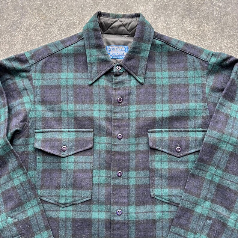 May include: A set of three ceramic mugs with a speckled, matte finish. The mugs are in shades of cream, light gray, and dark gray. Each mug has a simple, minimalist design and a rounded handle.