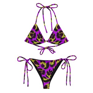 May include: Purple and green leopard print bikini with adjustable straps. The top is a triangle style and the bottom is a cheeky cut.
