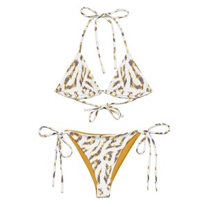 May include: White and yellow animal print bikini with adjustable straps. The top is a triangle style and the bottom is a cheeky style with ties on the sides.