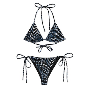May include: A black and blue bikini with a tie-side bottom and a triangle top. The bikini has a zebra print pattern.