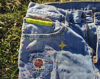 Wearable art jeans, mended, upcycled, hand embroidered, applique.