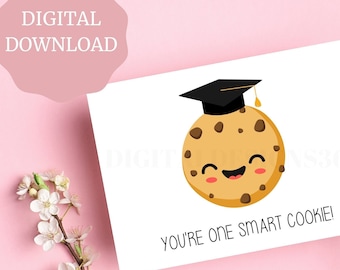 May include: A white card with a cartoon cookie wearing a graduation cap. The cookie has a smiling face and chocolate chips. The text on the card reads "You're one smart cookie!"