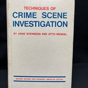 May include: A white book with a blue and red title: "Techniques of Crime Scene Investigation" by Arne Svensson and Otto Wendel. The book is a second, revised and expanded American edition.