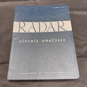 May include: A vintage blue book titled "RADAR circuit analysis" with white text. The book is from the Department of the Air Force. The cover has a faded appearance.