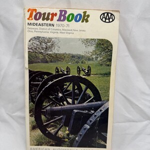 Puede incluir: Un TourBook AAA vintage para la región del Mideastern, que cubre Delaware, el Distrito de Columbia, Maryland, Nueva Jersey, Ohio, Pensilvania, Virginia y Virginia Occidental. La portada presenta cañones en un campo cubierto de hierba.