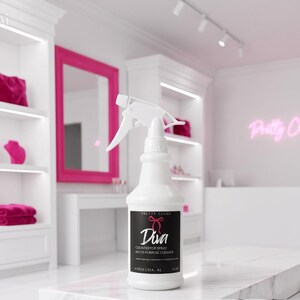 May include: A white plastic spray bottle with a trigger nozzle and a black label. The label features the text Pretty Clean, a pink bow icon, the word Diva, and the text Countertop Spray Multi-Purpose Cleaner, Andalusia, AL, 16 oz.