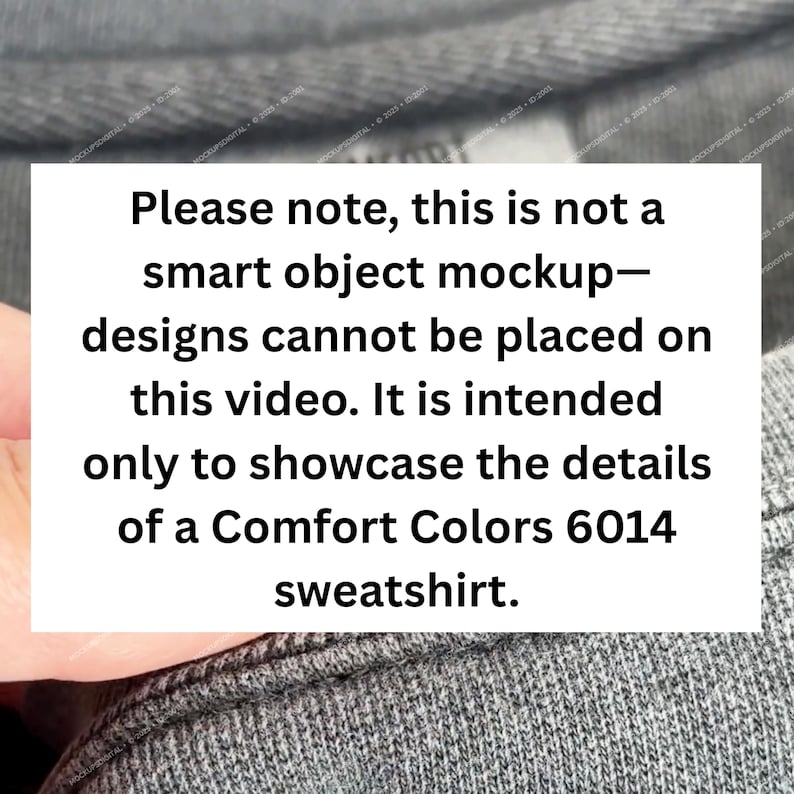 May include: A close-up of a gray Comfort Colors 6014 sweatshirt. The image includes a white rectangle with black text that reads: "Please note, this is not a smart object mockup&mdash;designs cannot be placed on this video."