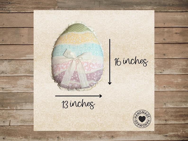May include: An egg-shaped pillow, approximately 16 inches tall and 13 inches wide, with a pastel color scheme. The pillow features layers of fabric in green, yellow, blue, and pink, with a white bow. The pillow is handmade.