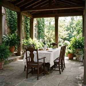 May include: A wooden dining set with a rectangular table covered by a white lace tablecloth and six matching chairs, positioned on a stone patio under a wooden pergola, surrounded by potted ferns and lush greenery in a garden setting.