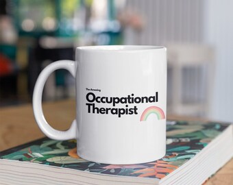 May include: White ceramic mug with a black and rainbow design that says "The Amazing Occupational Therapist".