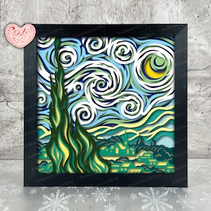 May include: A paper cut-out art piece depicting Vincent van Gogh's famous painting "Starry Night". The artwork features a swirling night sky with a bright yellow moon and a dark green cypress tree in the foreground. The town below is depicted with small, green houses.