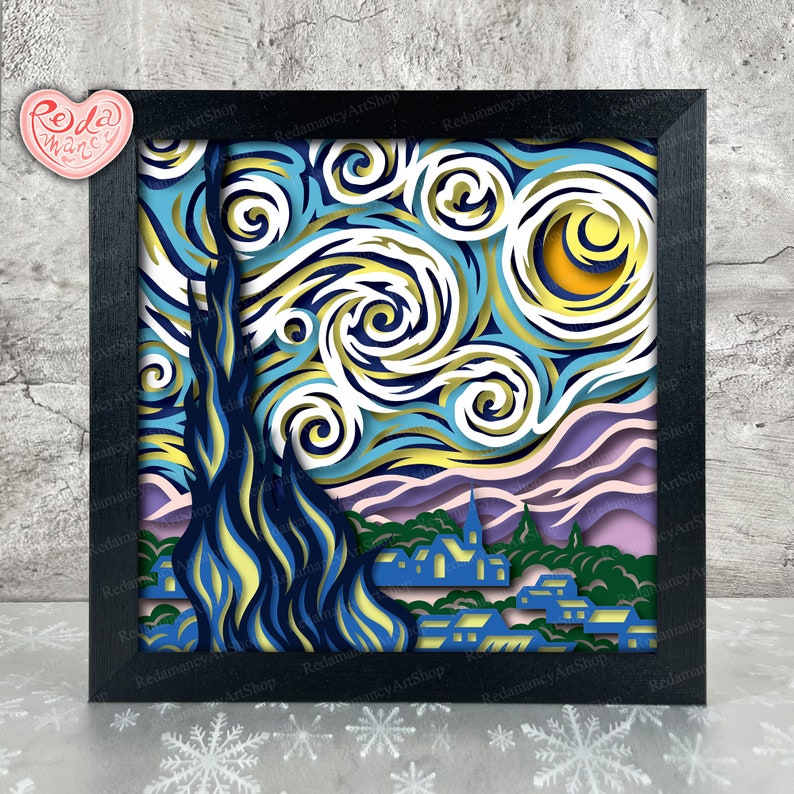May include: A black framed paper art piece depicting Vincent van Gogh's "Starry Night" with a layered, 3D effect. The artwork features swirling blue, yellow, and white stars against a dark blue sky, with a village scene at the bottom.