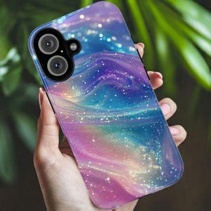 May include: A smartphone case featuring a swirling, iridescent nebula pattern in shades of purple, blue, and pink. The design includes a glittery, sparkling effect throughout the surface and a black camera module housing two circular lenses.