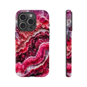 May include: A pink and purple agate phone case with a swirling pattern. The case is designed for an iPhone.