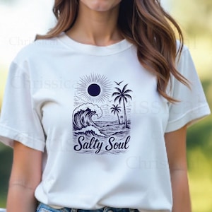 May include: White t-shirt with a blue graphic of a sun, palm trees, and a wave. The text "Salty Soul" is printed below the graphic.