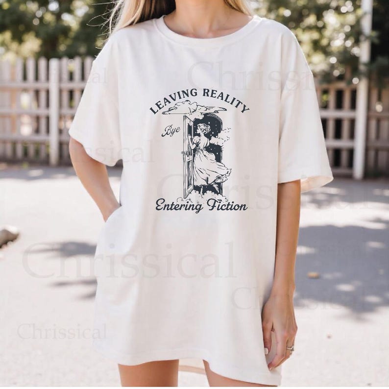 May include: A white oversized t-shirt with a graphic print of a woman stepping through a door with the text "Leaving Reality Bye Entering Fiction".