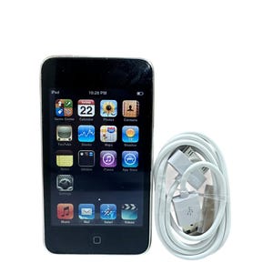 May include: Black iPod with a touch screen displaying various app icons, including music, mail, and Safari. A white charging cable is coiled next to the device. The screen shows the date as the 22nd and the time as 10:28 PM.