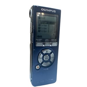 May include: A blue Olympus digital voice recorder with a small screen displaying "Root", "Folder 4", "Folder B", "Folder C", and "Folder D". The recorder has buttons labelled "Folder/A-BC", "List/Index", and "Display/Podcast".