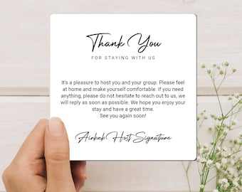 May include: A white card with black text that says "Thank You for staying with us." The card also includes a message thanking guests for staying and inviting them to reach out if they need anything. The card is signed "Airbnb Host Signature."