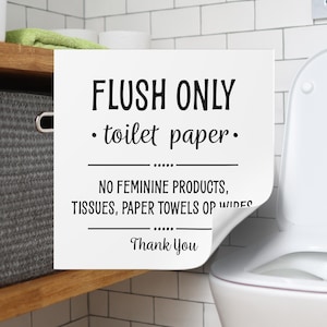 May include: A white sign with black text that reads "FLUSH ONLY - toilet paper." Below the text are the words "NO FEMININE PRODUCTS, TISSUES, PAPER TOWELS OP WIDES" and "Thank You."