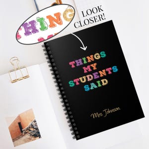 May include: A black spiral-bound notebook with the text "THINGS MY STUDENTS SAID" in colorful, textured letters and "Mrs. Johnson" in gold script. An oval inset shows a magnified view of the letters, and the text "LOOK CLOSER!" is visible.