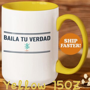 May include: White ceramic mug with a yellow interior and handle. The mug features the text "BAILA TU VERDAD" in blue, along with a graphic. The mug is labeled "Yellow 15oz".