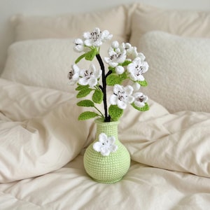 May include: A set of three ceramic vases in varying heights. The vases have a matte finish in shades of cream, beige, and brown. The tallest vase is approximately 10 inches high.