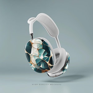 Op de afbeelding: Witte koptelefoon met een turquoise, gouden en wit geometrisch patroon op &eacute;&eacute;n oorschelp. De koptelefoon zweeft in de lucht.