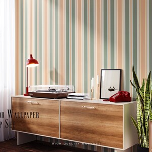 May include: A wooden dresser with two drawers, a record player, a lamp, a framed print, and a potted snake plant. The dresser is against a wall with a striped wallpaper in shades of green, orange, and white. The text "INTERIOR WALLPAPER MOCKUP SET" is visible in the image.