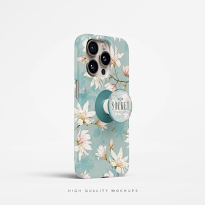 Puede incluir: Una funda de teléfono blanca con un diseño floral y un pop socket azul con el texto "POP SOCKET" en blanco.
