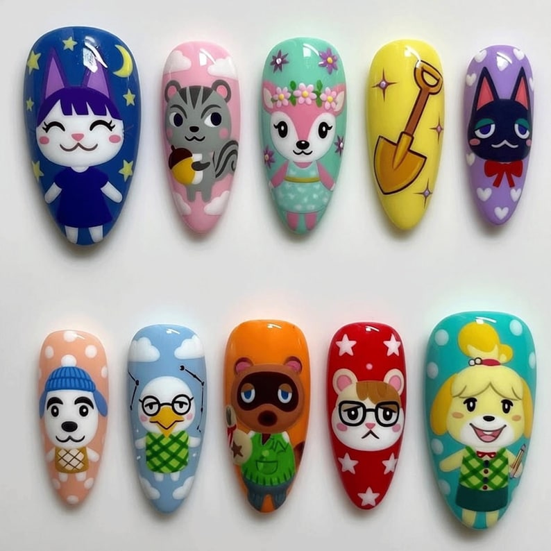 May include: A set of ten artificial nails, each painted with a different cartoon character design. The designs include a cat, squirrel, deer, and dog, among others. The nails are oval-shaped and feature a glossy finish, with a variety of colors including blue, pink, yellow, and orange.
