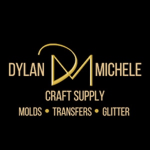 May include: A black background with the gold text "DYLAN MICHELE" and "CRAFT SUPPLY". Below, the text "MOLDS • TRANSFERS • GLITTER" is displayed in gold. The logo features a stylized "DM" in gold.