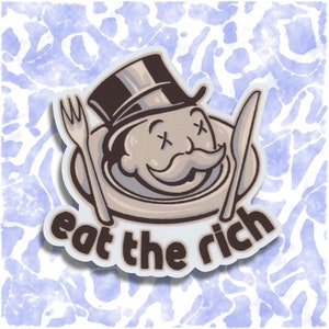 May include: A sticker with a cartoon image of a Monopoly man with an X over his eyes, a mustache, and a top hat. The Monopoly man is inside a plate with a fork and knife. The text "eat the rich" is below the plate.