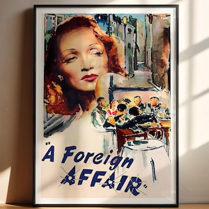 May include: Framed vintage movie poster for "A Foreign Affair." The artwork features a woman with red hair and red lipstick, with a scene of people at a table in the background. The title is in blue text.