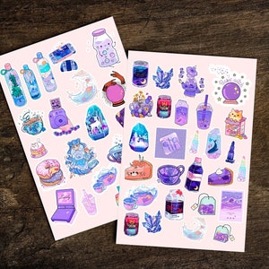 May include: Two sheets of stickers featuring a variety of cute illustrations in shades of purple, blue, and pink. The stickers include images of teacups, donuts, crystals, a cat, a witch, and more.