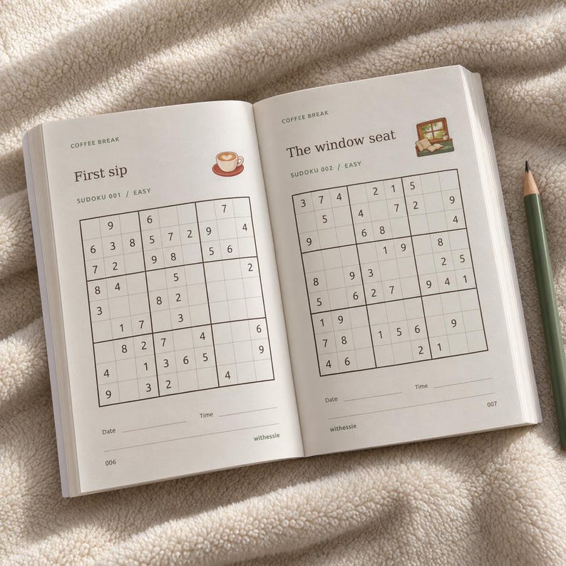 May include: An open book featuring two Sudoku puzzles titled First sip and The window seat. The pages include grid layouts with numbers, small illustrations of a coffee cup and a window, and lines for date and time. A dark green pencil lies beside the book.
