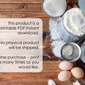 May include: A printable PDF instant download for a baking recipe. The image shows a wooden table with ingredients for baking, including flour, sugar, eggs, and chocolate. The text on the white card reads: "This product is a printable PDF instant download. No physical product will be shipped. One purchase - print as many times as you would like."