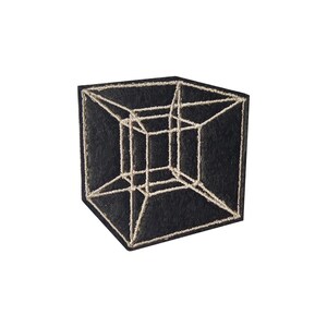 May include: A black square patch featuring a three-dimensional geometric cube design in a light beige color. The cube's lines are stitched onto the patch, creating a textured effect. The patch is likely for clothing or accessories.