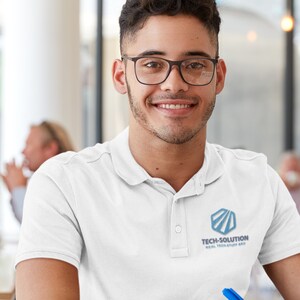May include: A man wearing a white polo shirt with a blue logo that says "Tech-Solution Real Tech Stuff Made" is smiling at the camera.