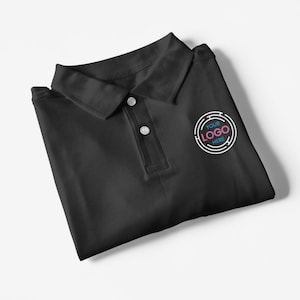 May include: Black polo shirt with a white embroidered logo that says "YOUR LOGO HERE" in a circle.
