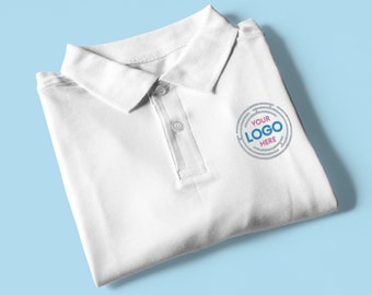 May include: White polo shirt with a folded collar and a button closure. The shirt has a small embroidered logo that says "YOUR LOGO HERE" in blue and pink text.