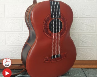 May include: A brown leather guitar-shaped backpack with a black strap and white stitching. The backpack has a black leather patch with a floral design. The image includes the text "Pdf Pattern + Free Tutorial Video".