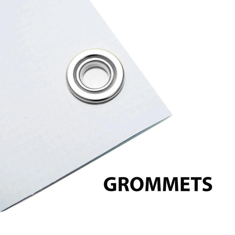 May include: Close-up of a white banner with a silver grommet. The banner has the word "GROMMETS" printed in black at the bottom.