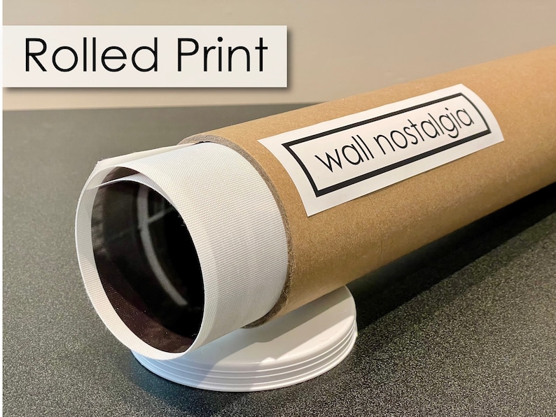 May include: A rolled print of a photograph or artwork is packaged in a brown cardboard tube with a white label that says "wall nostalgia".