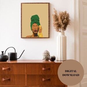 May include: Digital download of a minimalist illustration of a woman with brown skin wearing a green headscarf and gold jewellery. The background is a light brown colour.