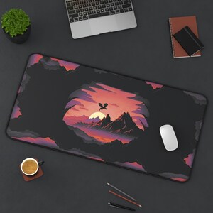 May include: A black and purple gaming mouse pad with a fantasy landscape design featuring a silhouette of a dragon flying over a mountain range. The design is set against a sunset sky with a dark cave in the foreground.