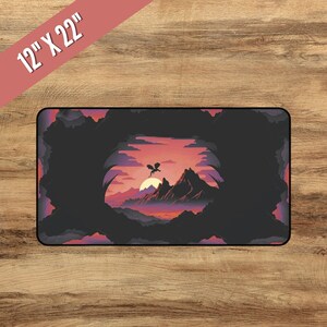 May include: A black and purple fantasy landscape with a silhouette of a dragon flying over a mountain range at sunset. The scene is framed by a dark, shadowy cave opening. The image is 12 inches by 22 inches.