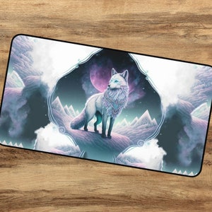 May include: A white arctic fox with blue eyes stands on a snowy mountain peak. The fox is surrounded by a purple and blue nebula with a pink moon in the background. The image is framed with a decorative border.