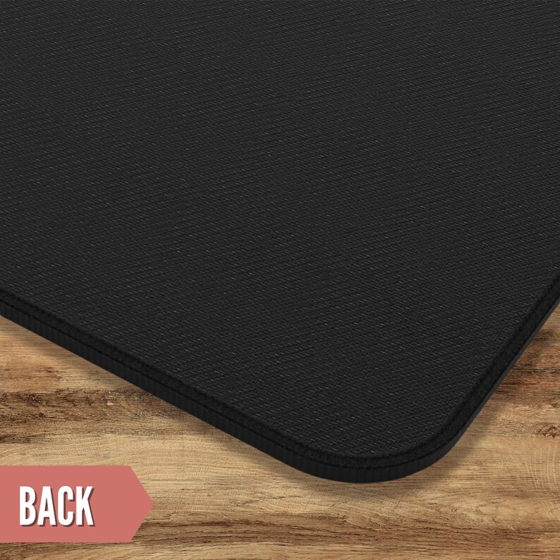 May include: Black mouse pad with a textured surface. The mouse pad has a stitched edge.